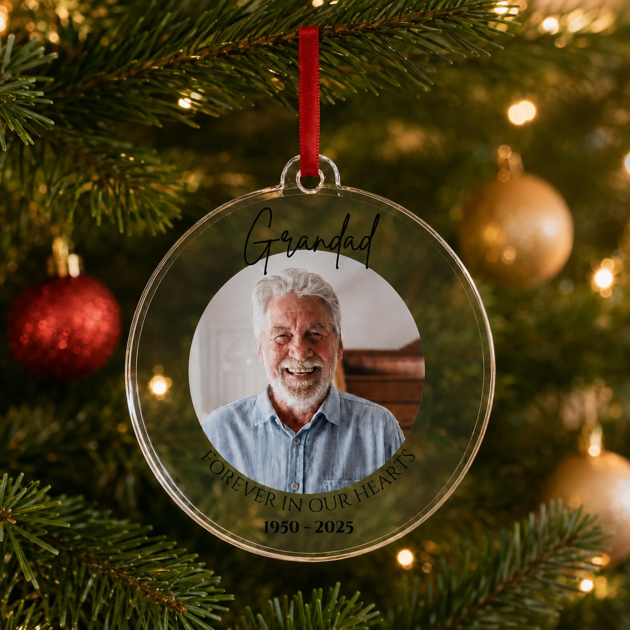 Memorial Christmas bauble hanging on a Christmas tree with warm lights