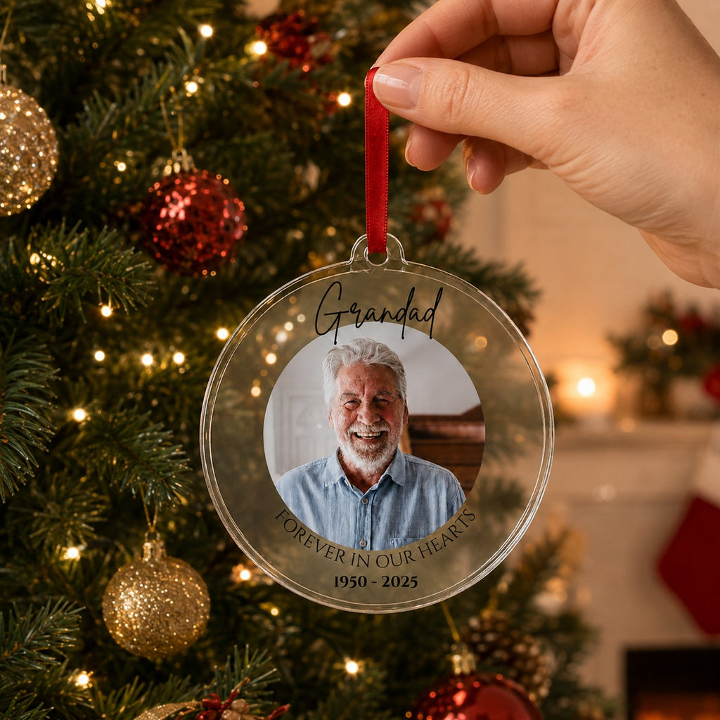 Memorial Christmas bauble held by its red ribbon