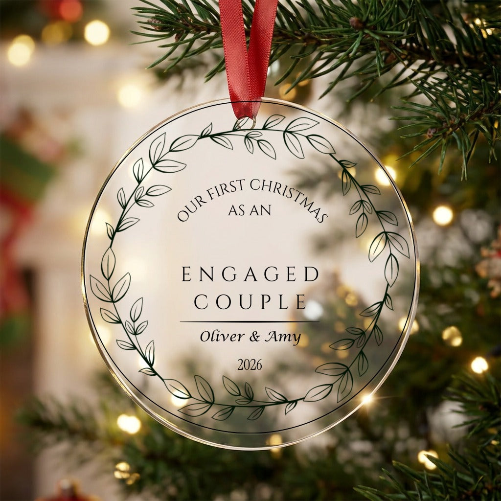 Personalised first Christmas engaged couple acrylic bauble with names and year hanging on a Christmas tree