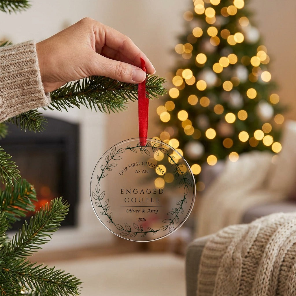 Hand hanging the personalised engagement bauble on the Christmas tree