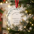 Personalised family of three first Christmas acrylic bauble with family name and year hanging on a Christmas tree