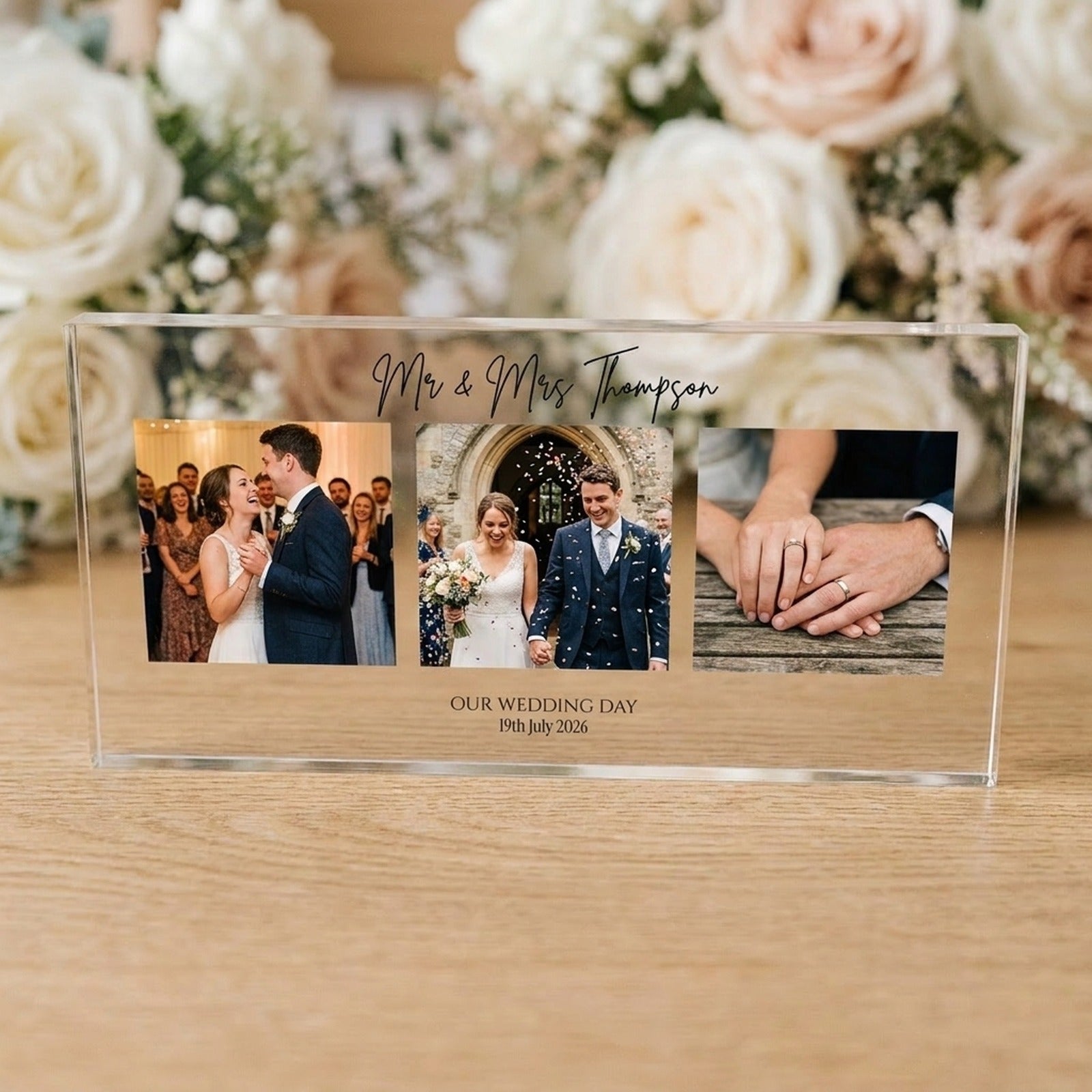 Wedding photo collage acrylic block displayed on an oak table with soft florals