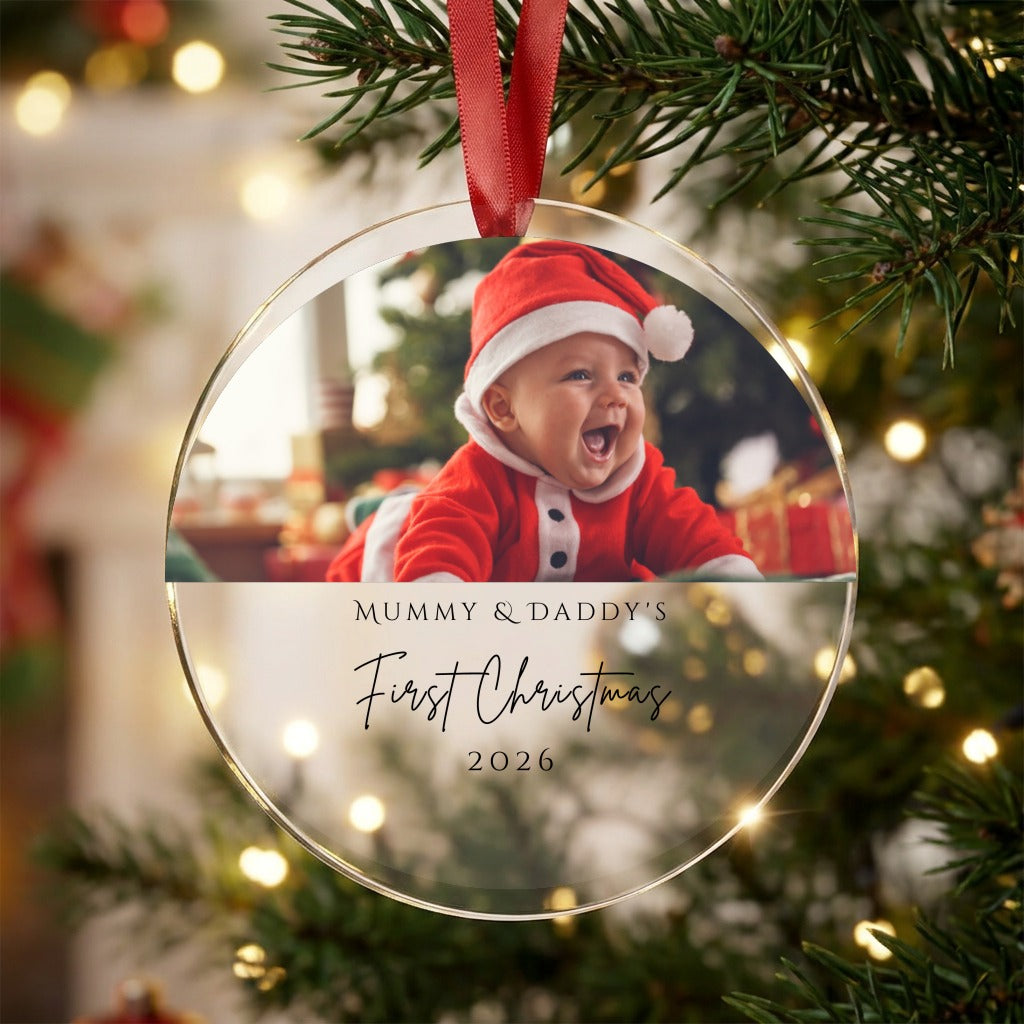 Personalised Mummy and Daddy first Christmas photo bauble with baby photo and year hanging on a Christmas tree