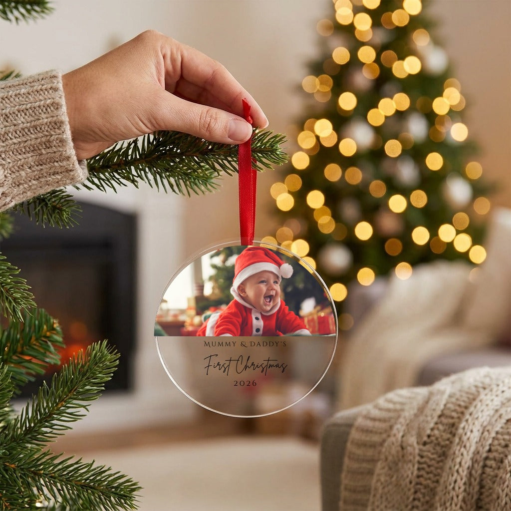 Hand hanging the personalised Mummy and Daddy photo bauble on the Christmas tree