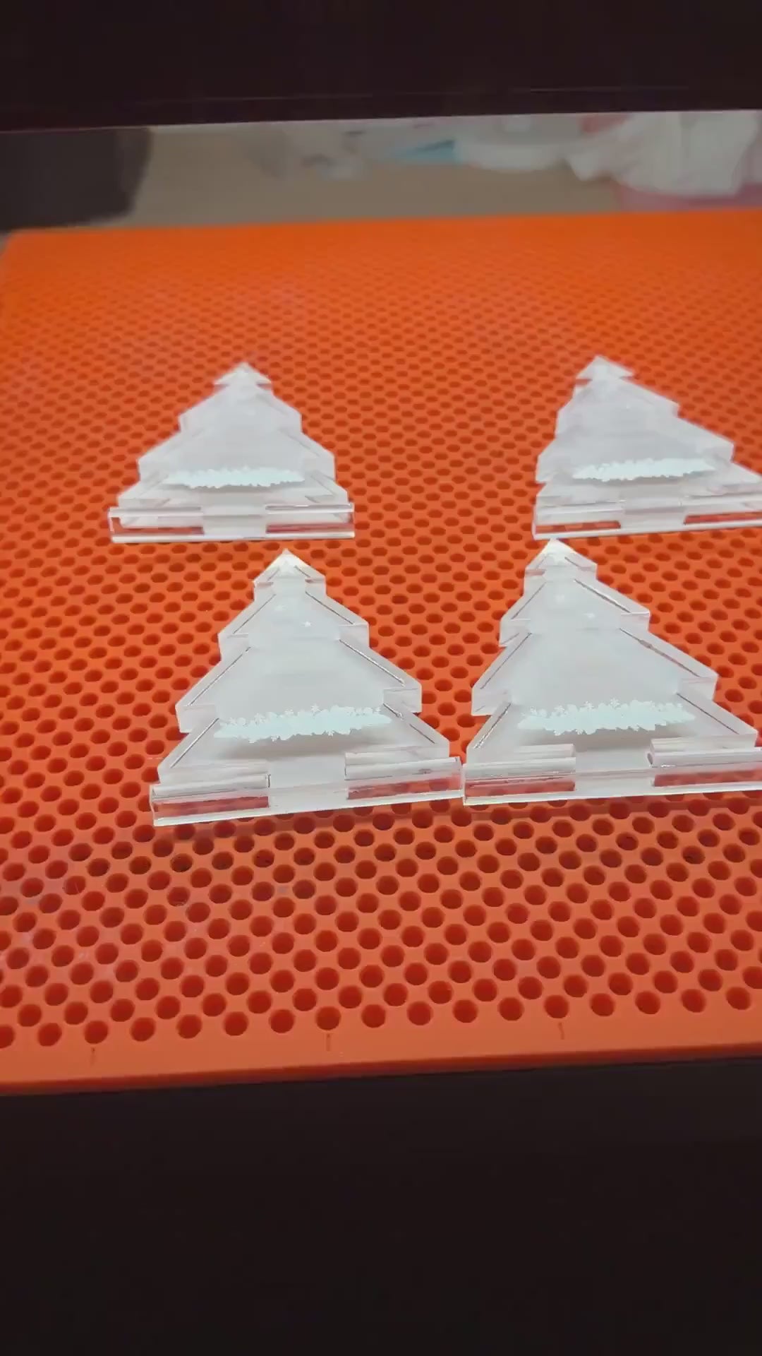 Personalised acrylic Christmas tree place names being made
