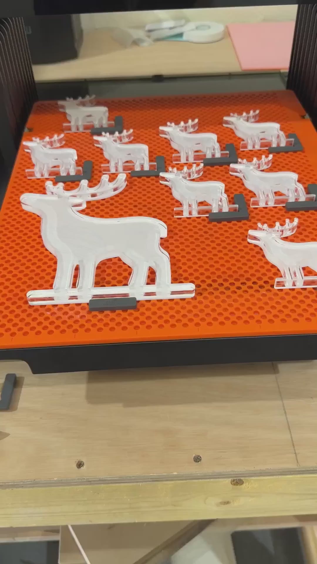 Personalised clear acrylic reindeer place names being made